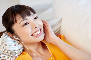 Image showing happy asian woman with earphones listening music