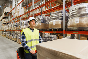 Image showing man on forklift loading cargo at warehouse