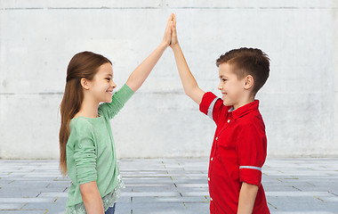 Image showing happy boy and girl making high five