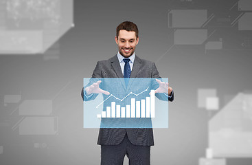 Image showing businessman working with virtual chart projection