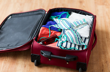 Image showing close up of travel bag with beach clothes