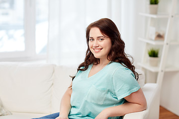 Image showing happy young plus size woman at home