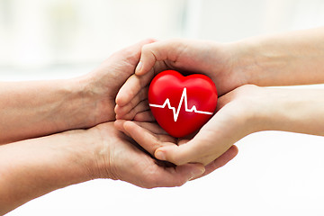 Image showing man hand giving red heart to woman