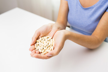 Image showing close up of woman hands with medicine or pills