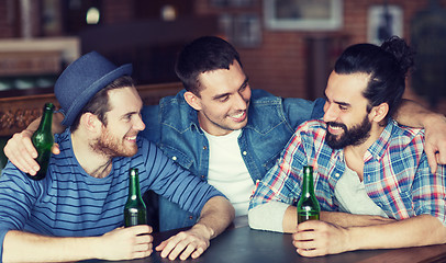 Image showing happy male friends drinking beer at bar or pub