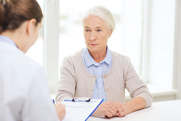 Image showing doctor with clipboard and senior woman at hospital