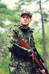 Image showing young soldier or hunter with gun in forest