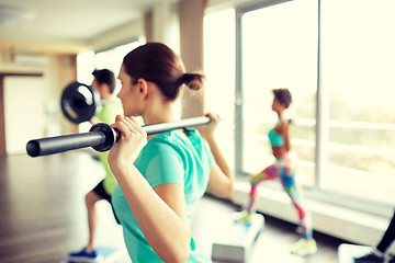 Image showing close up of people exercising with bars in gym