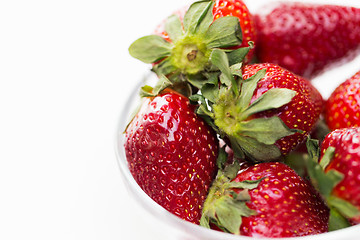 Image showing close up of ripe red strawberries over white