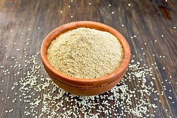 Image showing Flour sesame in clay bowl on board