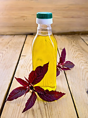 Image showing Oil with amaranth in bottle on light board