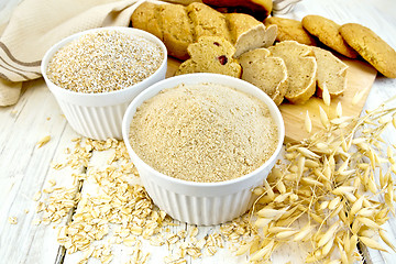 Image showing Flour oat in white bowl with bread on board