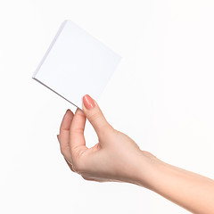 Image showing Female hand holding blank paper for records on white.