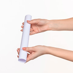 Image showing The cylinder female hands on white background