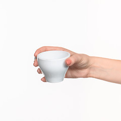 Image showing Woman hand with cup on white background