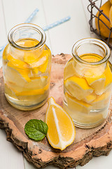 Image showing Lemon and lime slices in jars