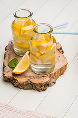 Image showing Lemon and lime slices in jars