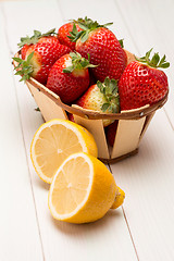 Image showing Strawberries in a small basket and lemon