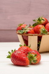 Image showing Strawberries in a small basket and lemon