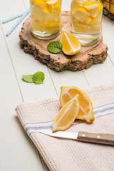 Image showing Lemon and lime slices in jars