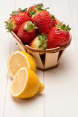 Image showing Strawberries in a small basket and lemon