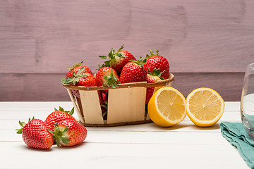 Image showing Strawberries in a small basket and lemon