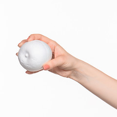 Image showing The female hand holding white blank styrofoam oval 