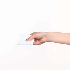 Image showing Female hand holding blank paper for records on white.