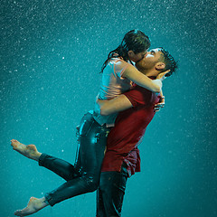 Image showing The loving couple in the rain