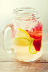 Image showing close up of fruit water in glass bottle