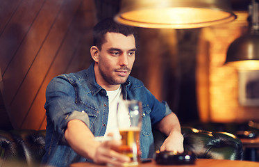 Image showing man drinking beer and smoking cigarette at bar