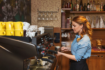 Image showing barista woman making coffee by machine at cafe