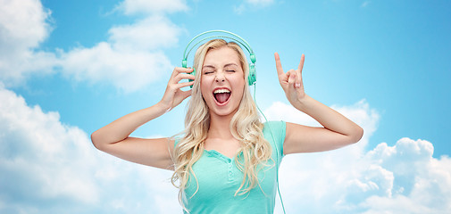 Image showing happy young woman or teenage girl with headphones