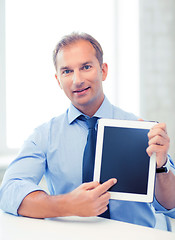 Image showing smiling businessman with tablet pc in office