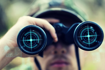 Image showing close up of soldier or hunter with binocular