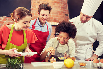 Image showing happy friends and chef cook baking in kitchen