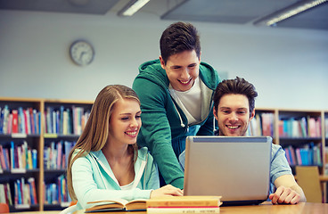 Image showing happy students with laptop in library