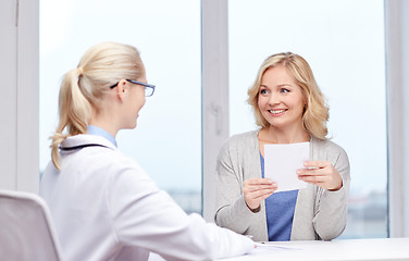 Image showing doctor giving prescription to woman at hospital