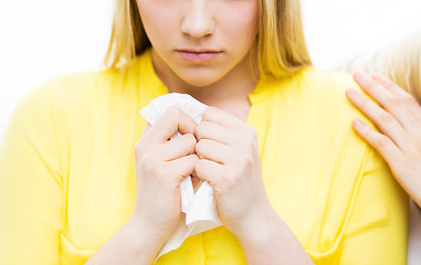 Image showing close up of crying teenage girl and friend hand