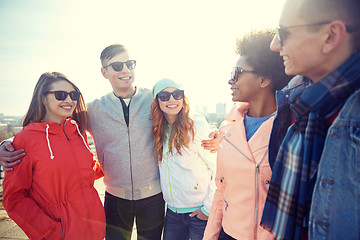 Image showing happy teenage friends in shades talking on street