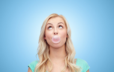 Image showing happy young woman or teenage girl chewing gum