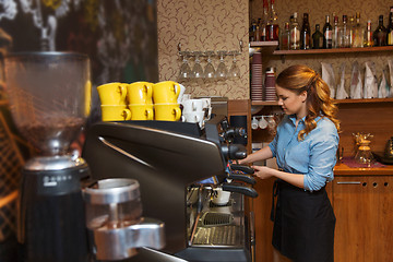 Image showing barista woman making coffee by machine at cafe