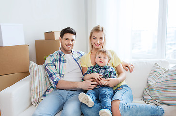 Image showing happy family with boxes moving to new home