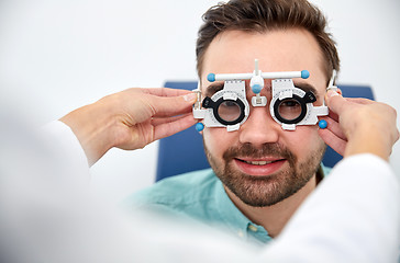 Image showing optician with trial frame and patient at clinic