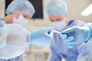 Image showing close up of hands with scalpel at operation