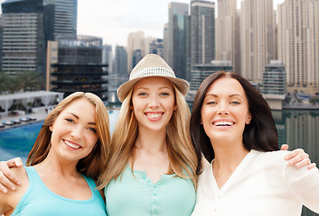 Image showing young women over dubai city harbour and boats