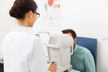 Image showing optician with autorefractor and patient at clinic