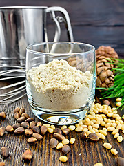 Image showing Flour cedar in glass with sieve on board