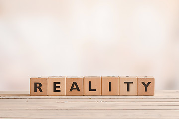 Image showing Reality sign on a table of wood