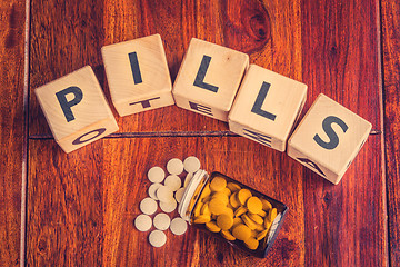 Image showing The word pills on a table